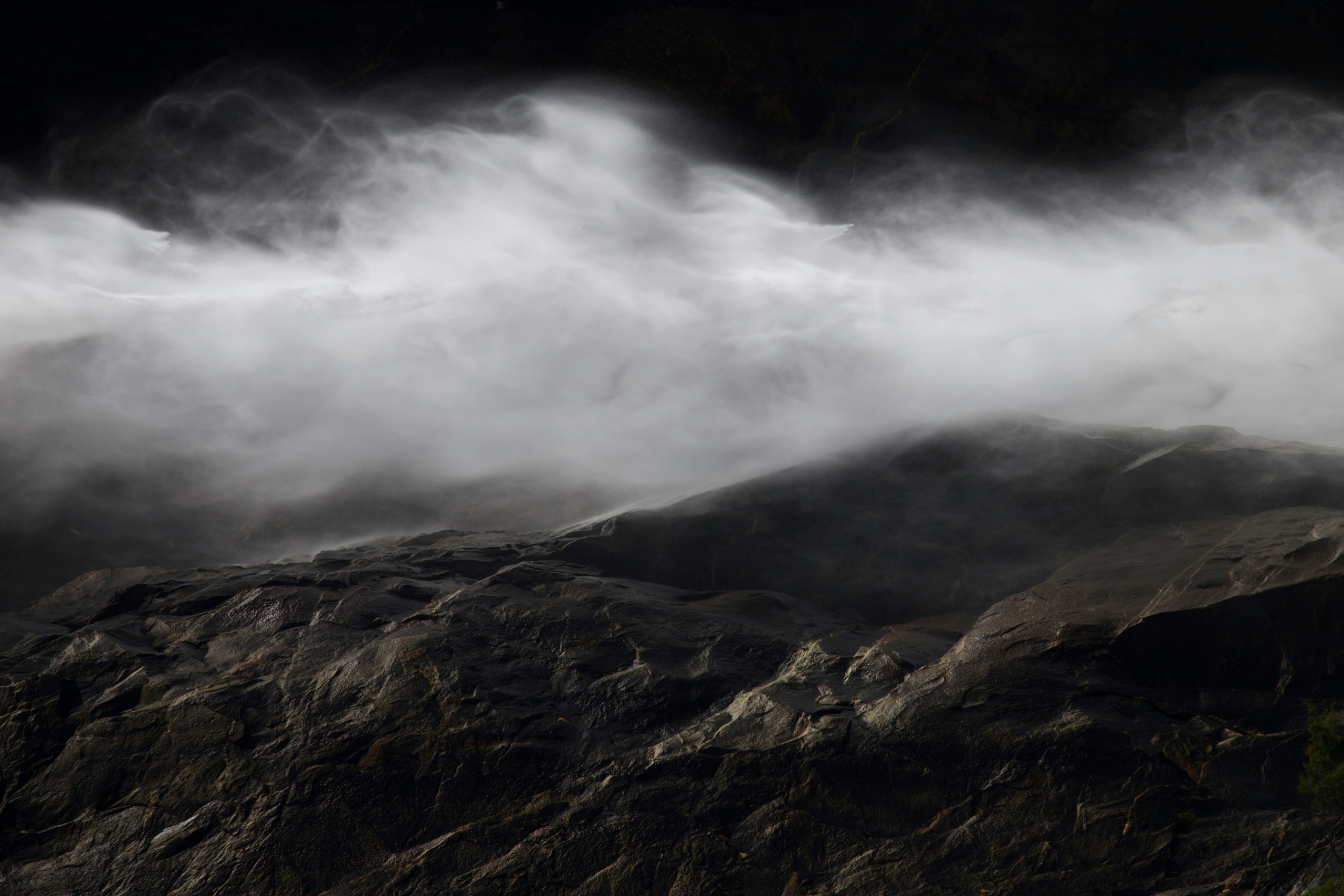 Mist moving over dark granite in the Tuolumne high country